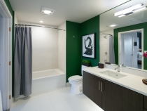 Bathroom with big mirror and green walls